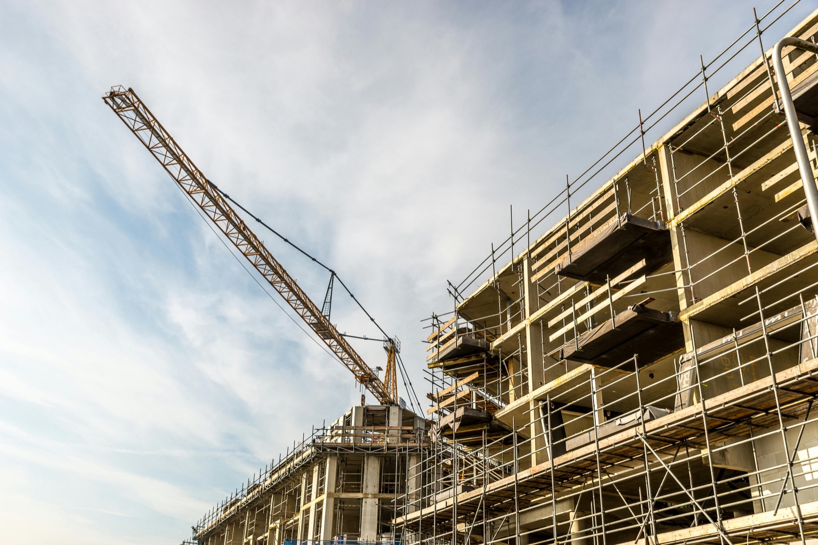 Modern construction site with crane and active scaffolding